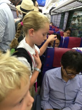 Tessa unsuccessfully  tries to will the man in front of her to stand. We rode 40 minutes like this.