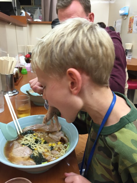 Cy tucks into a bowl of ramen.